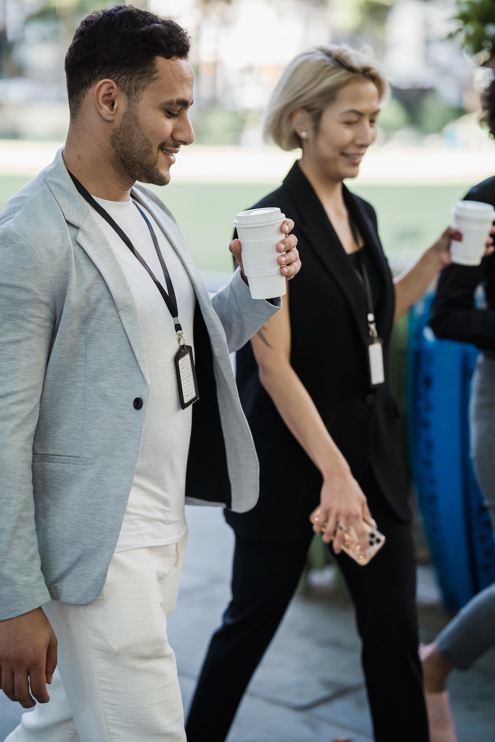 2 personnes sur un salon avec un café et un téléphone à la main avec des badges, heureux de la marketplace événementielle proposée sans aucun doute